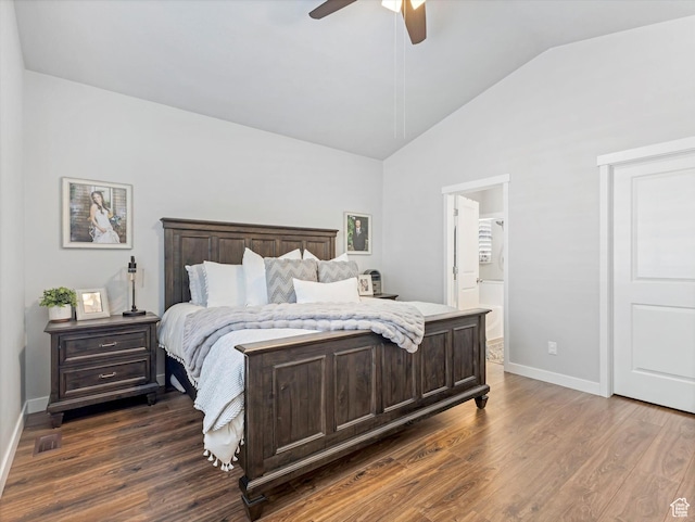 bedroom featuring dark hardwood / wood-style flooring, connected bathroom, vaulted ceiling, and ceiling fan