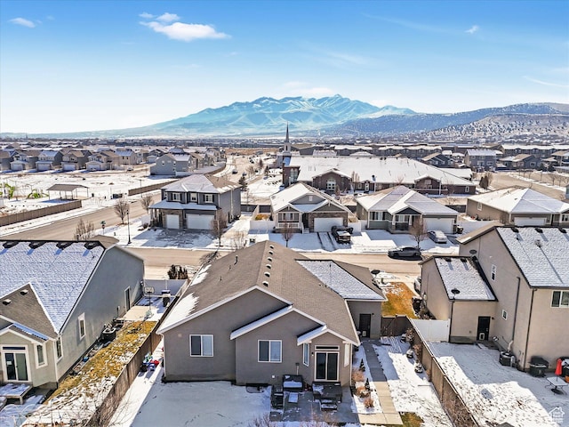 snowy aerial view featuring a mountain view