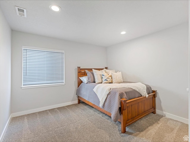 bedroom featuring light colored carpet