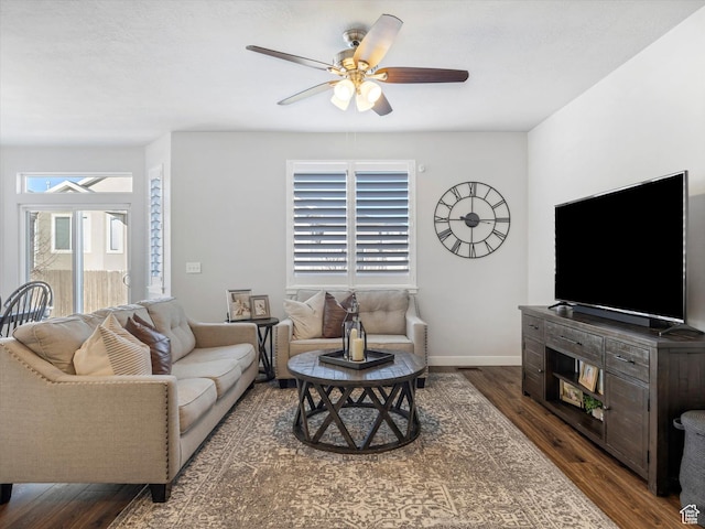 living room with dark wood-type flooring and ceiling fan