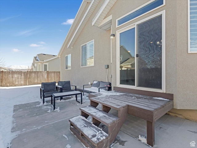 snow covered patio with an outdoor hangout area