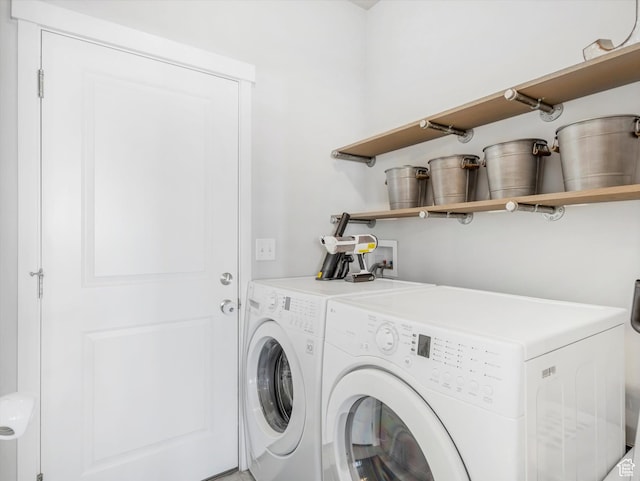 clothes washing area with washing machine and dryer
