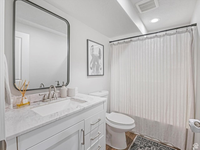 bathroom featuring hardwood / wood-style flooring, vanity, and toilet