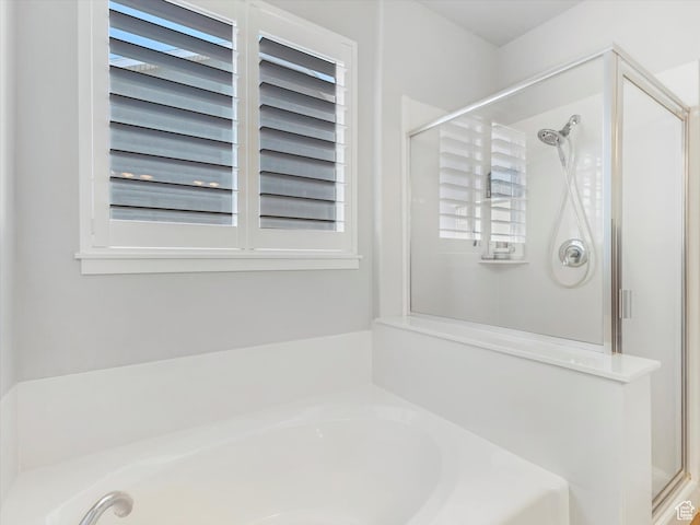 bathroom with separate shower and tub