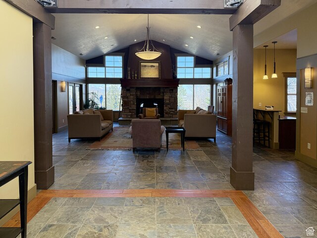 127 E Chandlerpoint Way S, Draper, UT 84020 - living room featuring stone tile flooring, a stone fireplace, high vaulted ceiling, and baseboards