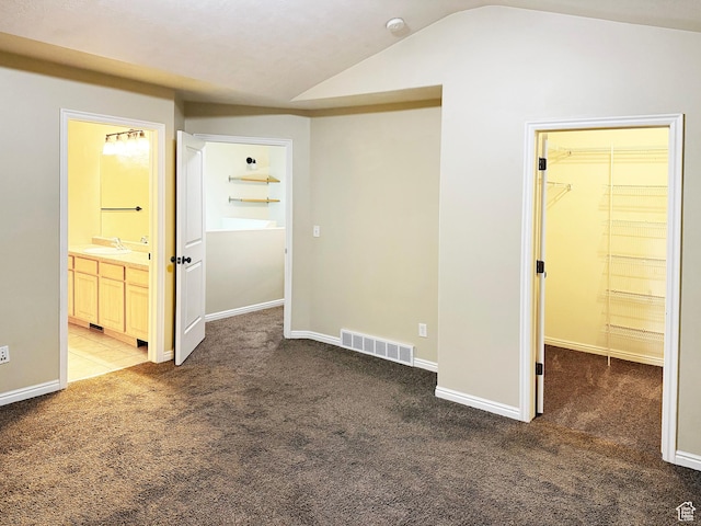 127 E Chandlerpoint Way S, Draper, UT 84020 - unfurnished bedroom featuring visible vents, a sink, vaulted ceiling, a walk in closet, and carpet flooring