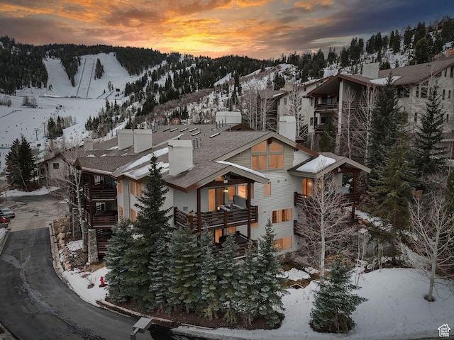snowy aerial view with a mountain view