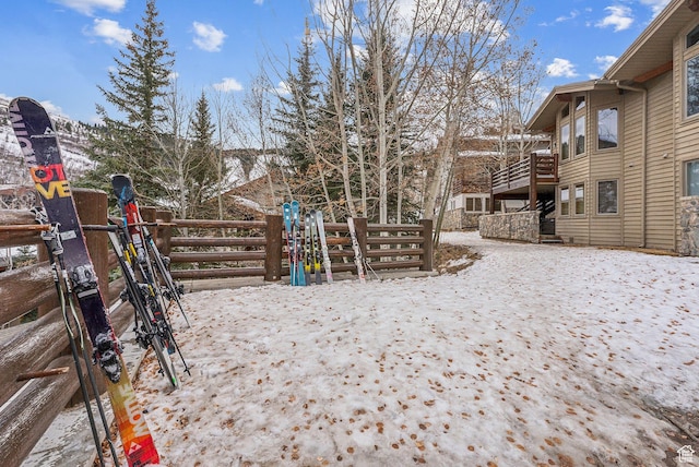 yard covered in snow featuring a mountain view