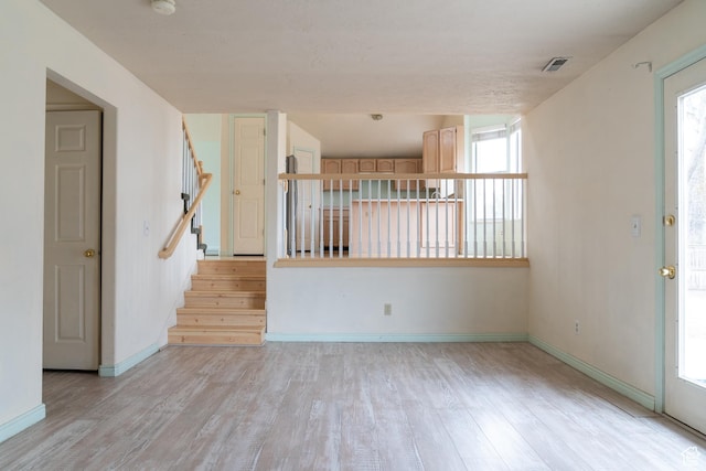 spare room featuring light hardwood / wood-style flooring