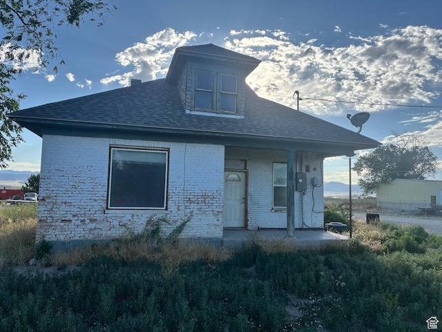 105 W 400 N, Centerfield, UT 84622 - rear view of property featuring brick siding, a porch, and roof with shingles