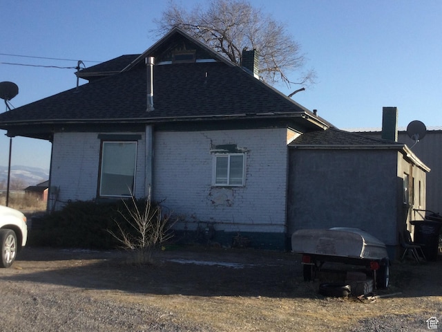 105 W 400 N, Centerfield, UT 84622 - view of side of property with brick siding, roof with shingles, and a chimney