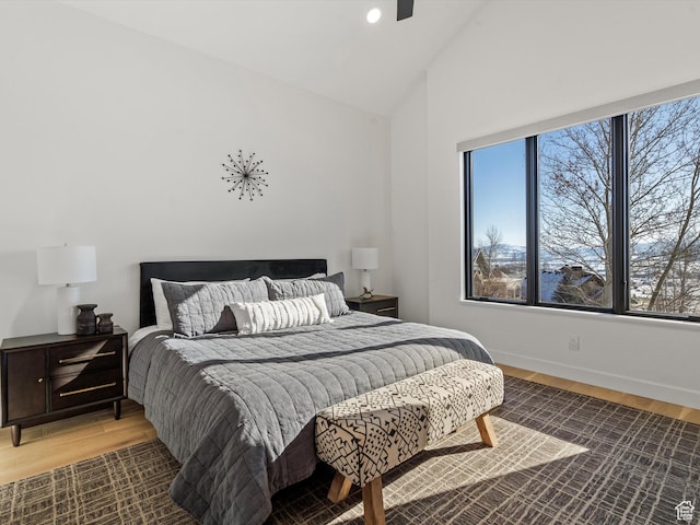 bedroom with recessed lighting, high vaulted ceiling, baseboards, and light wood-style floors
