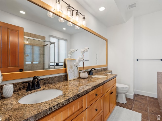 full bathroom with visible vents, a stall shower, double vanity, and a sink