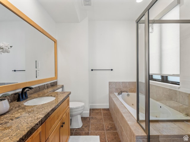 bathroom with vanity, a whirlpool tub, toilet, visible vents, and baseboards