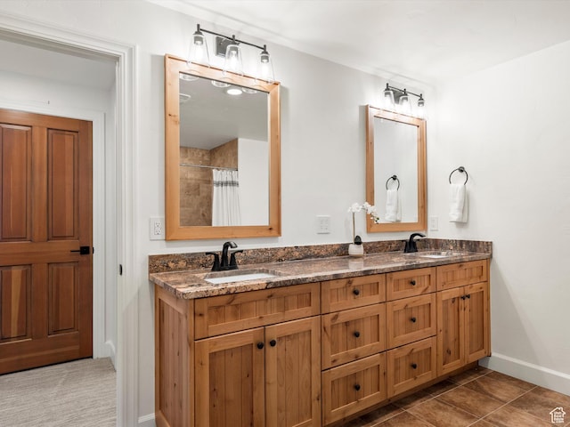 full bathroom with double vanity, baseboards, a shower with curtain, and a sink