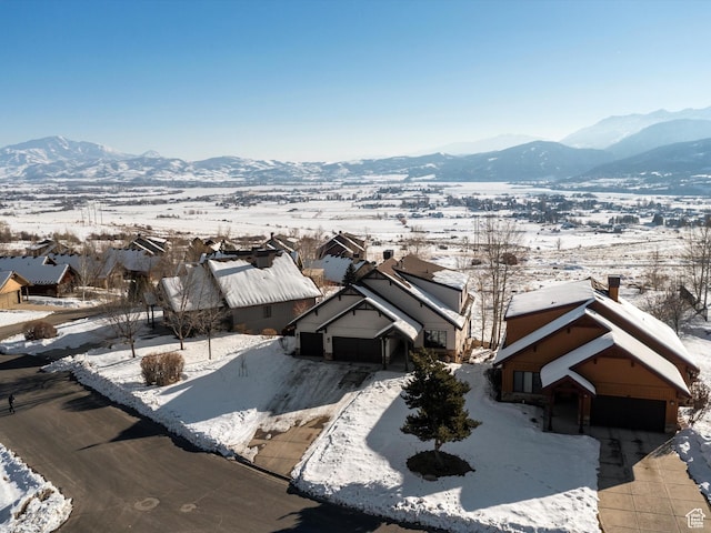 snowy aerial view featuring a mountain view