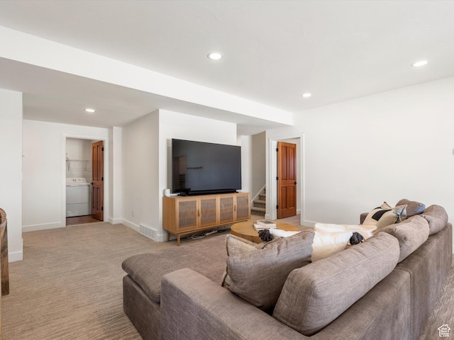 living area featuring baseboards, recessed lighting, light carpet, washer / dryer, and stairs
