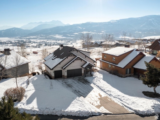 snowy aerial view featuring a mountain view