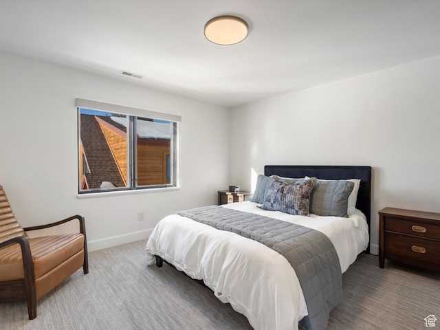 bedroom with carpet, visible vents, and baseboards