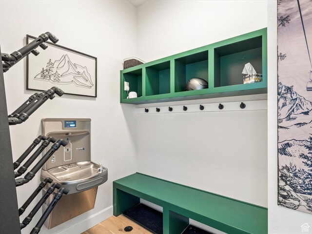 mudroom featuring wood finished floors and baseboards