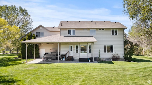 rear view of house featuring a yard, entry steps, and a patio area