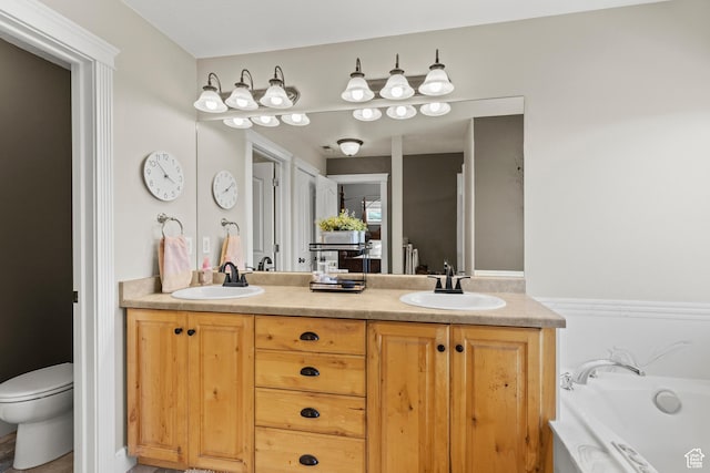 bathroom with a garden tub, double vanity, and a sink