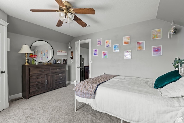 bedroom featuring vaulted ceiling, light carpet, baseboards, and a ceiling fan