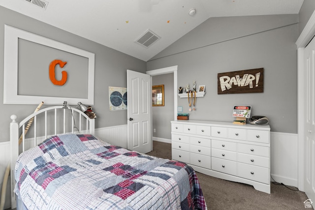 bedroom featuring vaulted ceiling, a wainscoted wall, visible vents, and carpet floors