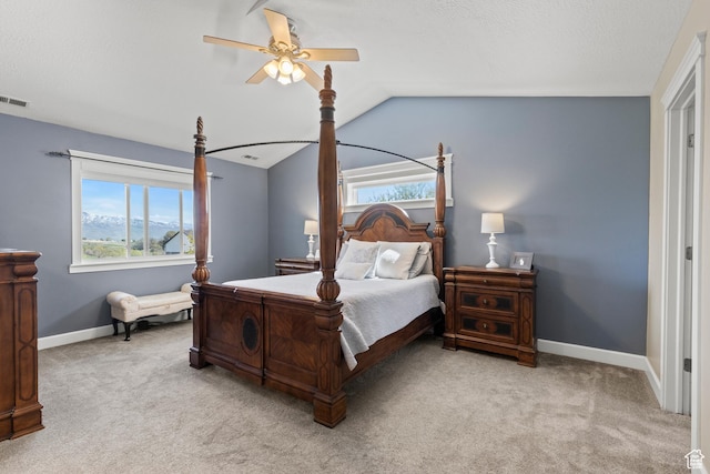 carpeted bedroom with lofted ceiling, baseboards, and ceiling fan