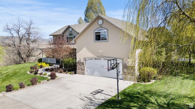 view of home's exterior with an attached garage, stone siding, driveway, a yard, and stucco siding