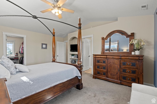 bedroom with lofted ceiling, carpet, a ceiling fan, and visible vents