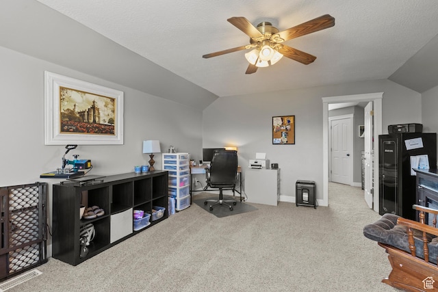 carpeted home office featuring lofted ceiling, baseboards, and a ceiling fan