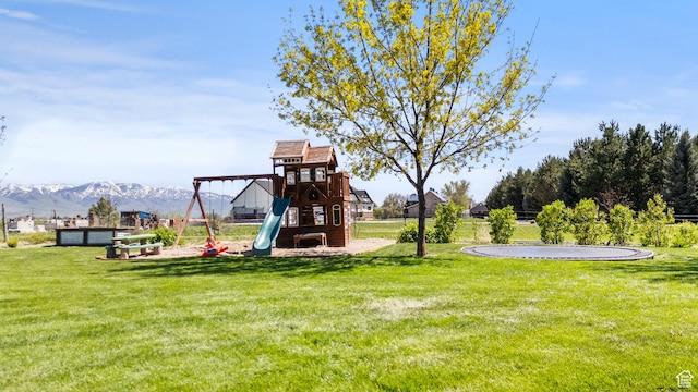 view of playground with a mountain view and a yard