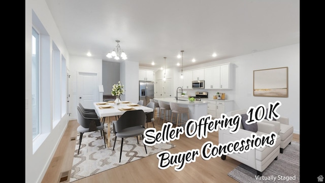 dining space featuring an inviting chandelier, light wood-style floors, recessed lighting, and visible vents