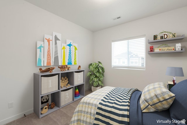 carpeted bedroom with visible vents and baseboards