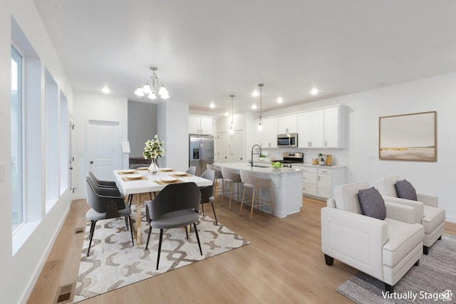 dining room with recessed lighting, visible vents, a chandelier, and light wood-type flooring
