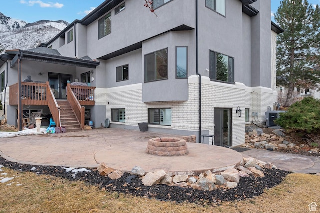 1533 Rosanna Ln, Alpine, UT 84004 - rear view of house featuring a mountain view, a patio area, and a fire pit