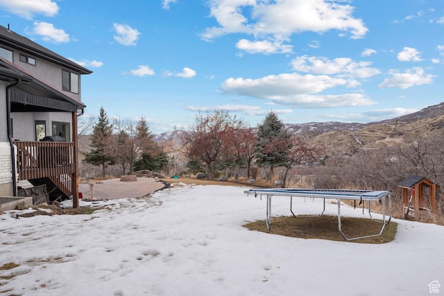 1533 Rosanna Ln, Alpine, UT 84004 - yard layered in snow featuring a mountain view and a trampoline