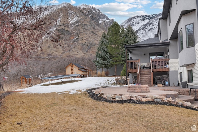 1533 Rosanna Ln, Alpine, UT 84004 - snowy yard featuring a storage unit, a mountain view, a patio area, and a trampoline