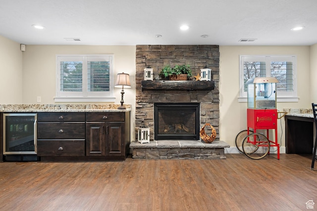 1533 Rosanna Ln, Alpine, UT 84004 - living room featuring wine cooler, a stone fireplace, and hardwood / wood-style flooring