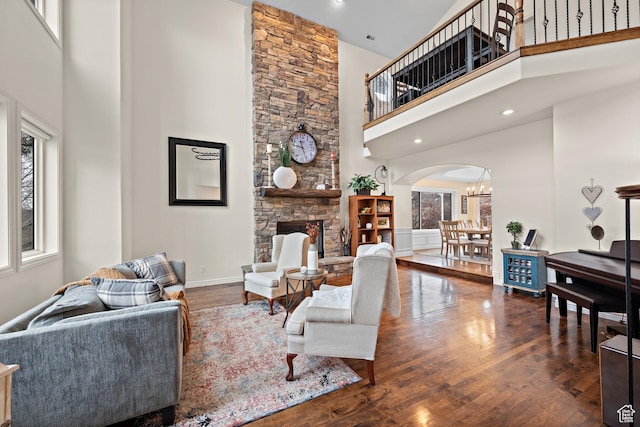 1533 Rosanna Ln, Alpine, UT 84004 - living room featuring dark hardwood / wood-style floors, a chandelier, a fireplace, and a towering ceiling