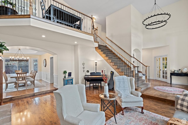 1533 Rosanna Ln, Alpine, UT 84004 - living room with an inviting chandelier, a towering ceiling, french doors, and hardwood / wood-style flooring