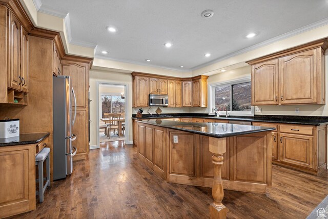 1533 Rosanna Ln, Alpine, UT 84004 - kitchen featuring dark stone countertops, stainless steel appliances, a center island, ornamental molding, and dark hardwood / wood-style flooring