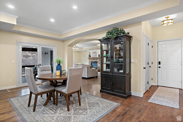 1533 Rosanna Ln, Alpine, UT 84004 - dining space with ornamental molding, french doors, dark hardwood / wood-style flooring, a stone fireplace, and a raised ceiling