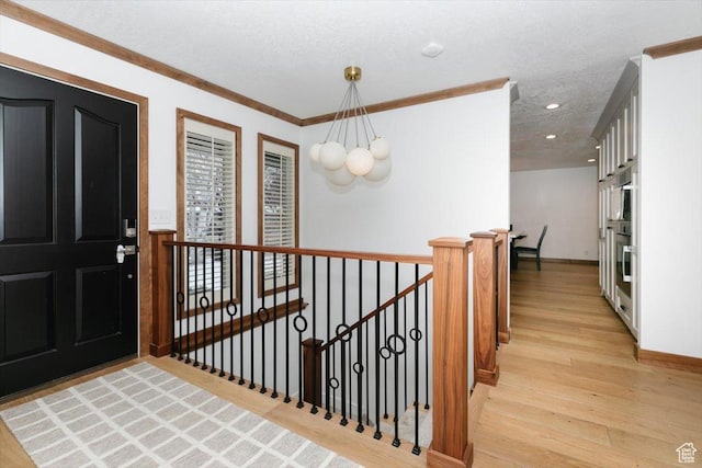 1453 E 1200 N, Logan, UT 84341 - foyer entrance featuring a chandelier, light wood-style flooring, recessed lighting, a textured ceiling, and crown molding