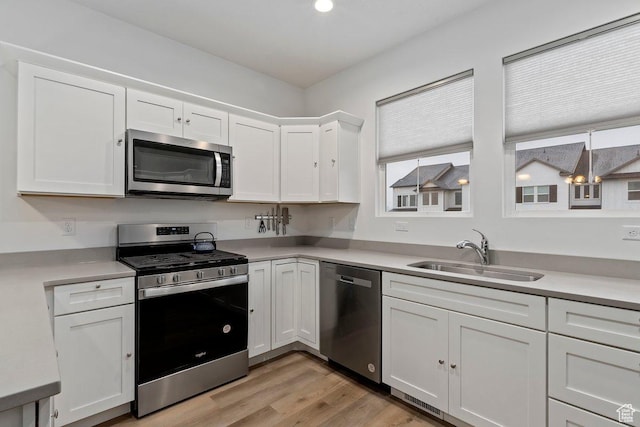 2075 N 4100 W Unit 473, Lehi, UT 84043 - kitchen with sink, white cabinets, and appliances with stainless steel finishes