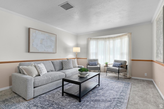carpeted living area with visible vents, baseboards, a textured ceiling, and ornamental molding