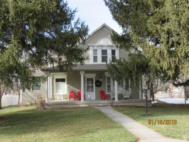 291 N Main St, Hyde Park, UT 84318 - view of front of home featuring a front lawn and covered porch