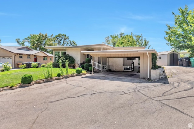 1737 N Sego Ln, Provo, UT 84604 - ranch-style home featuring a front lawn, a carport, and a storage unit
