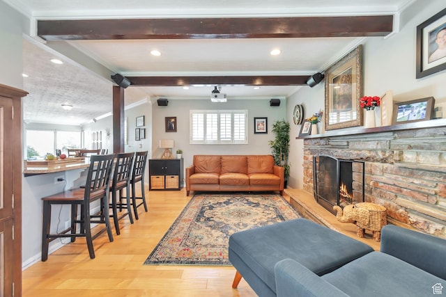 1737 N Sego Ln, Provo, UT 84604 - living room featuring ornamental molding, a stone fireplace, lofted ceiling with beams, and light hardwood / wood-style flooring
